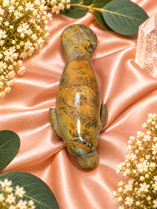 Picture Jasper Manatees gemstone from Gemstone Oasis Co., featuring detailed, earth-toned carved stone figurines of gentle manatees.